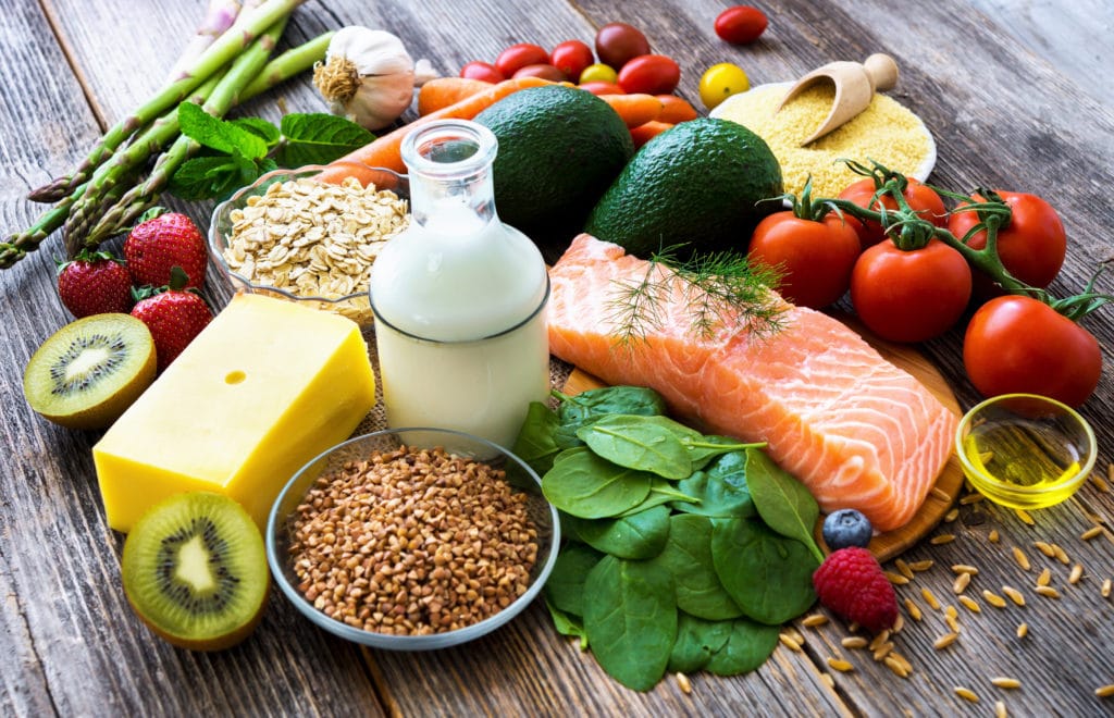 Featured: Healthy foods displayed on wooden table - Prepare Your Fit Grocery List